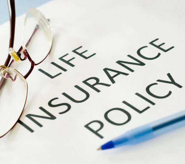A life insurance policy is written on top of the paper.