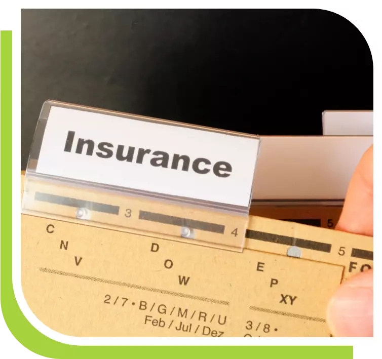 A person is holding an insurance card in their hand.